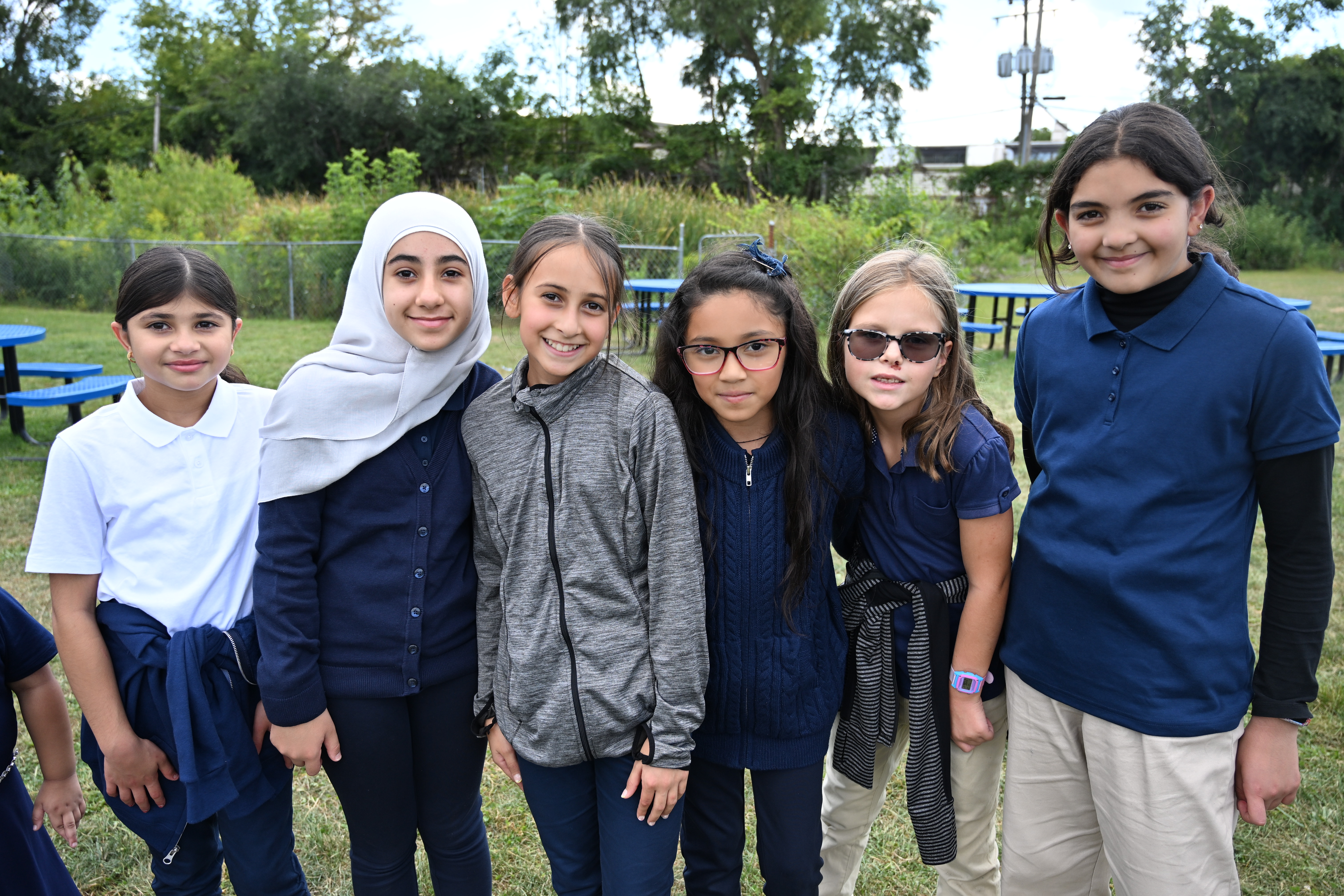 Central Academy students smiling together outside